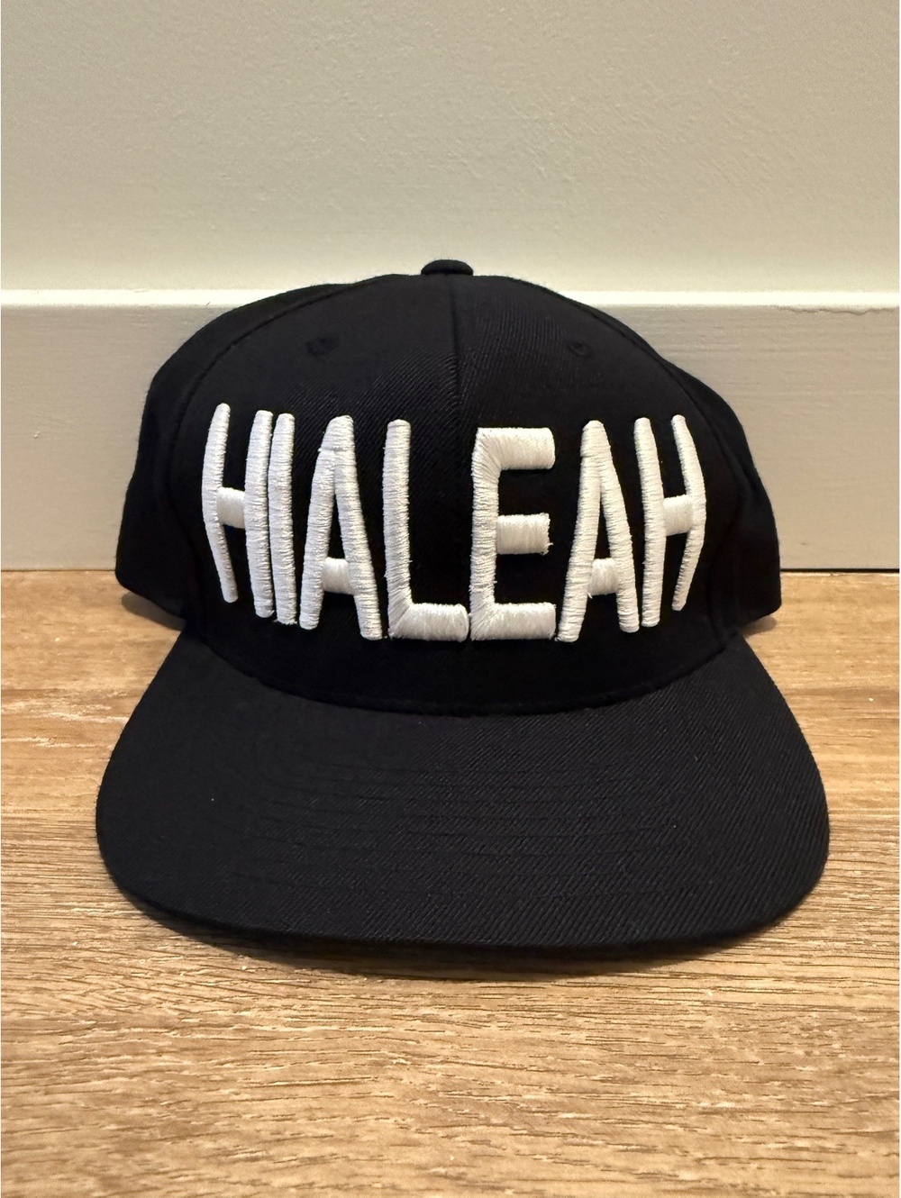 Black “Hialeah” Snapback Hat with Green Underside Brim
